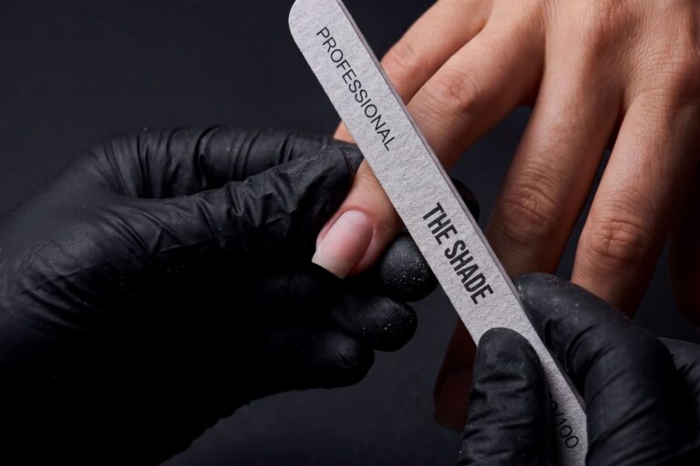 Dry manicure at The Shade — a specialist shaping a nail with a branded professional file